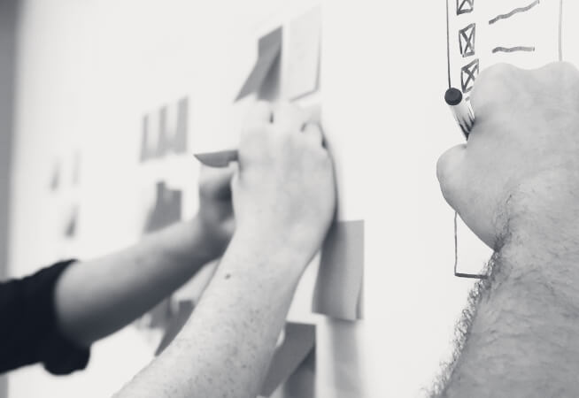 people writing on board