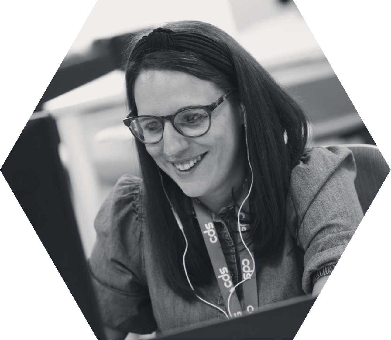 person smiling while sitting at computer